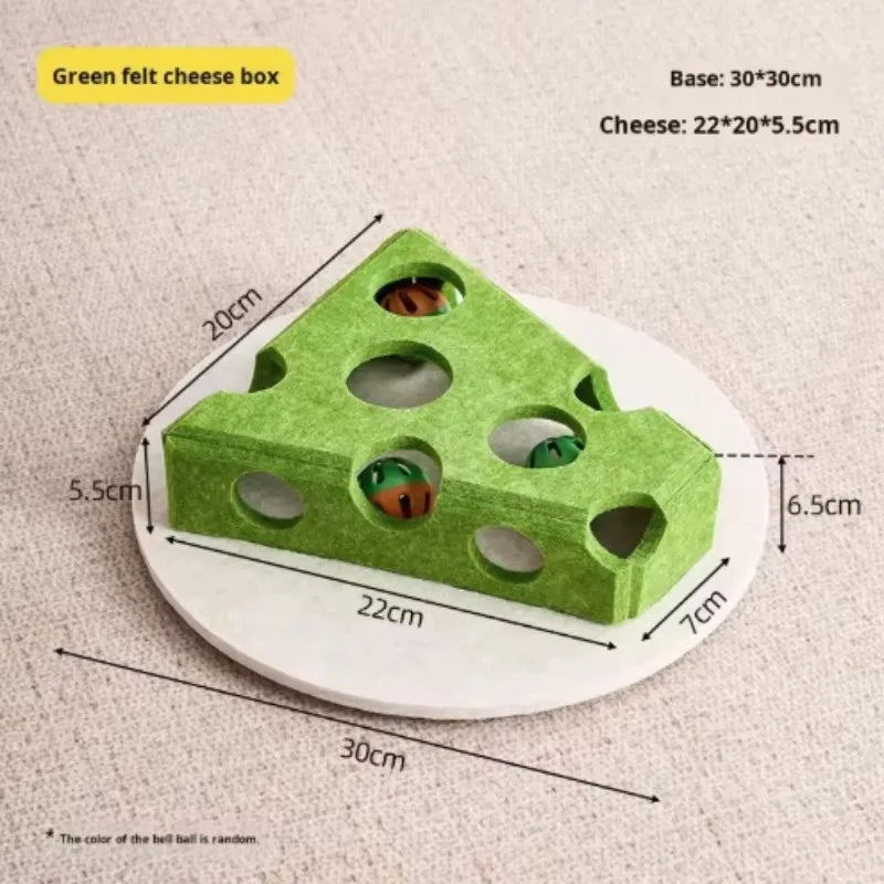 A green felt cheese box puzzle featuring holes and a bell ball.