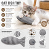 A kitten is playing with a gray and white striped fish plush toy designed for interactive fun.