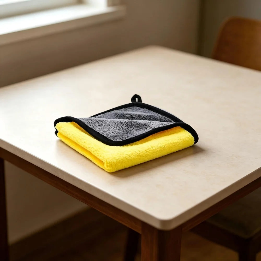 A yellow ultra-absorbent pet drying towel is folded on a light wooden table.