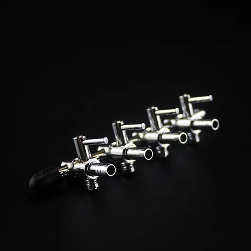 A close-up shot of a silver 5-way aquarium air flow splitter valve with multiple outlets.