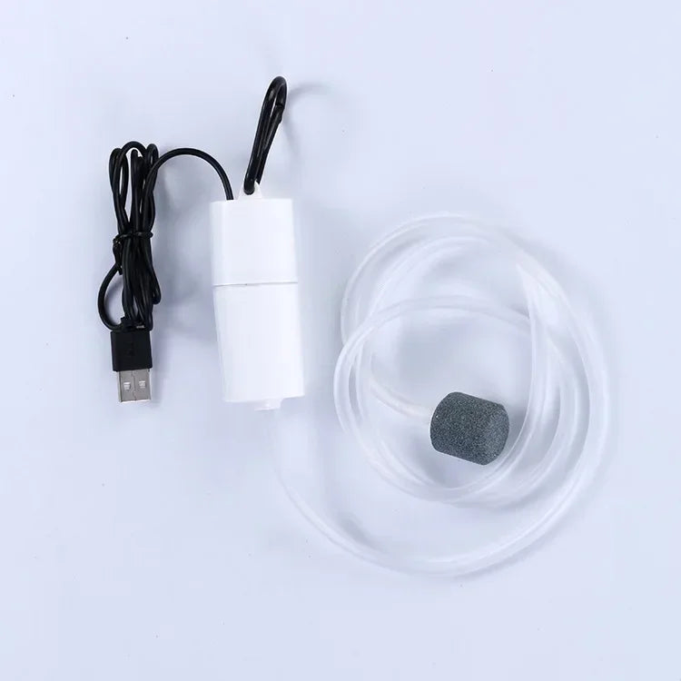 A white USB silent air pump with a black cord and a clear silicone tubing is shown on a white background.