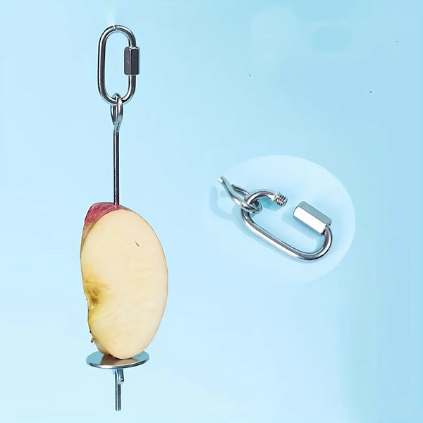 Stainless steel parrot feeder with a hook holding an apple.