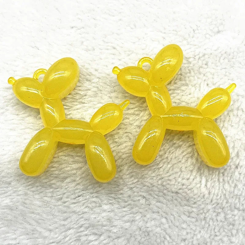 Two yellow acrylic balloon dog charm pendants for jewelry making and keychains