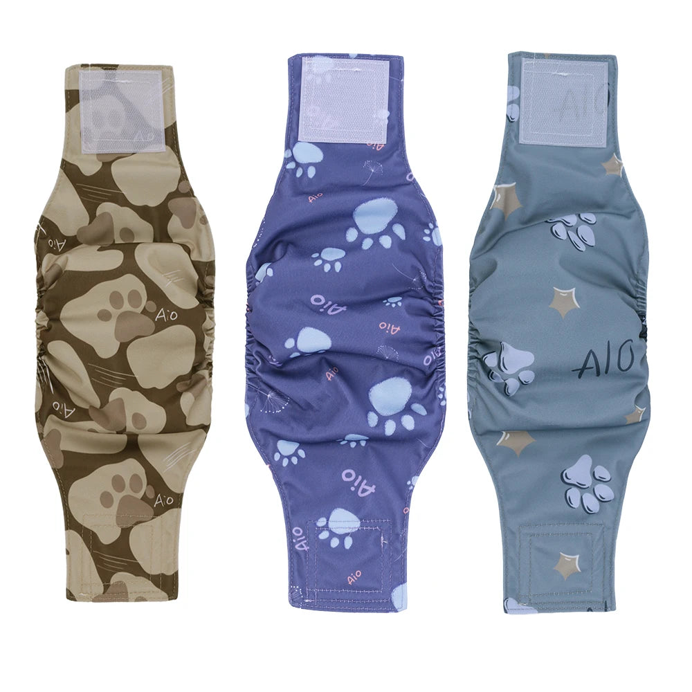 Three reusable dog belly bands in brown, purple, and gray fabric with paw print designs.