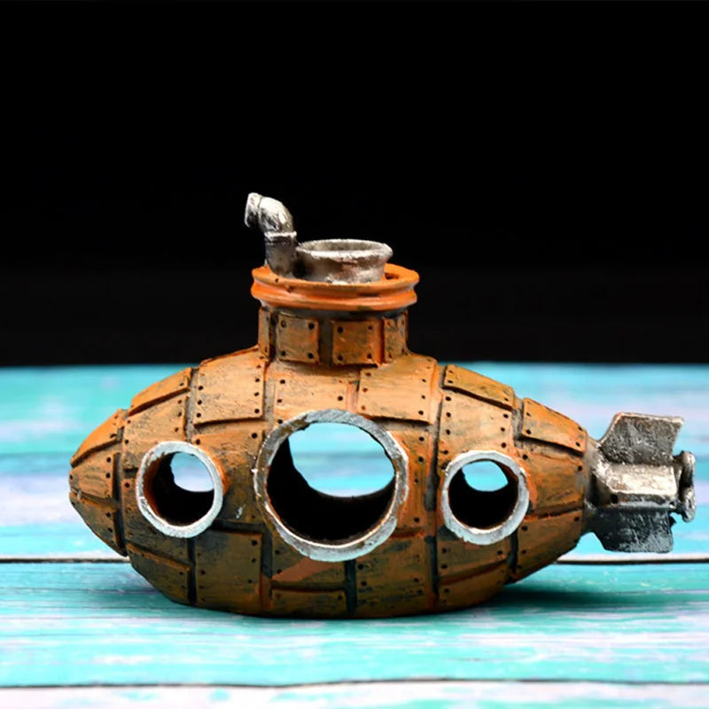 A vintage-style resin submarine ornament with an orange-brown body and silver top, resting on a light blue wooden surface.