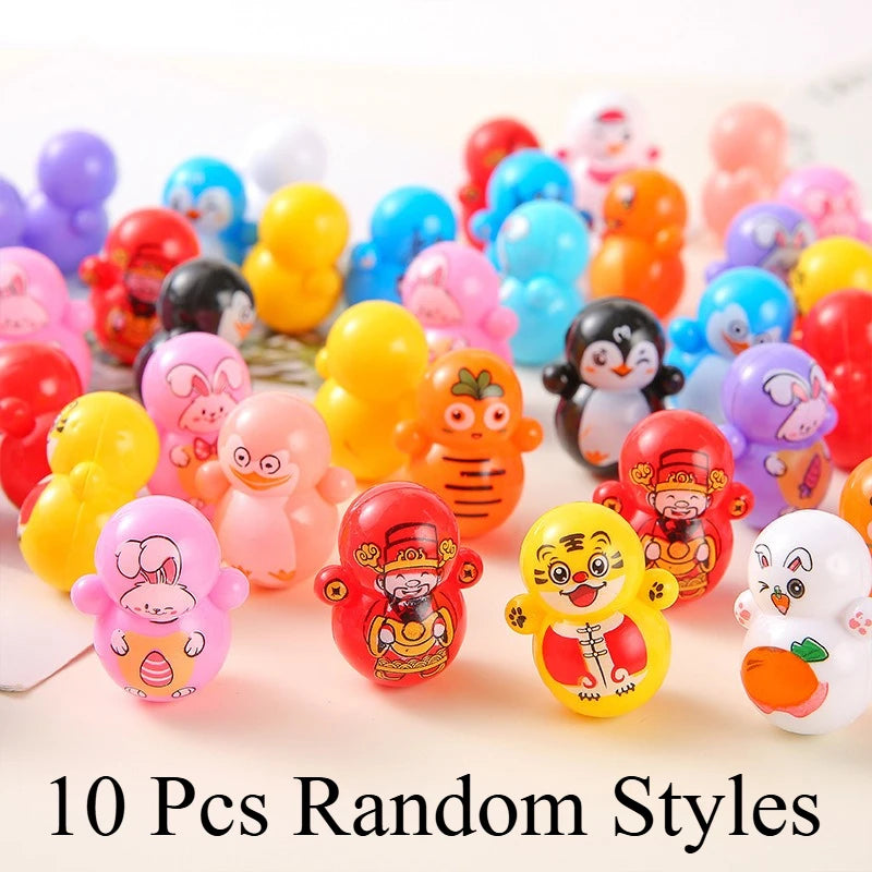 A collection of ten colorful self-rolling cat toys in various styles and colors arranged on a white background.