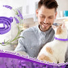 A man holds a white and orange cat wearing a purple pheromone calming collar.