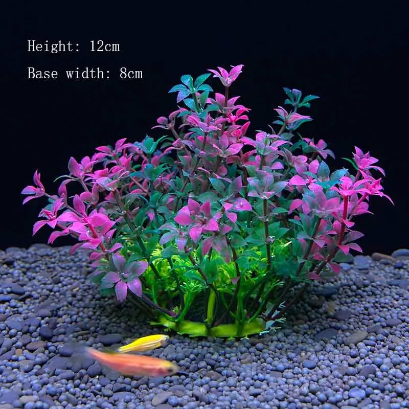 A vibrant artificial aquarium plant with pink and green leaves is displayed on a dark gravel substrate.