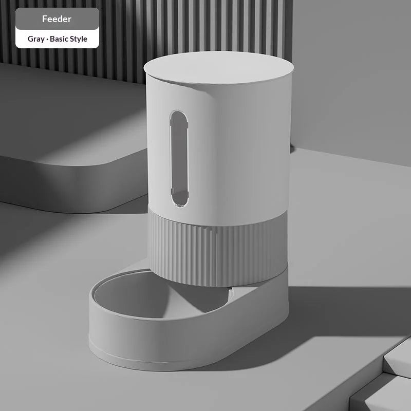 A white automatic gravity pet feeder and water dispenser combo with a cylindrical design, shown on a light gray surface.