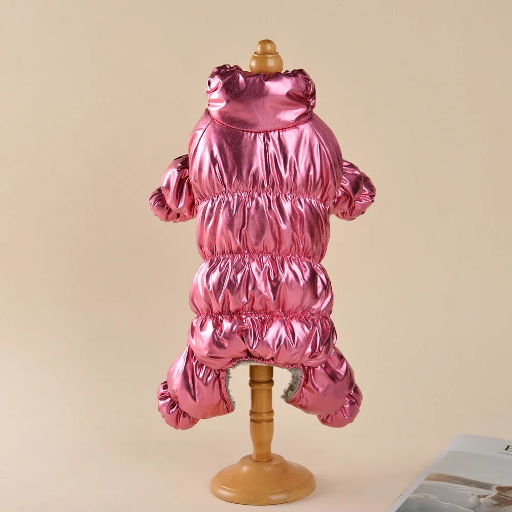 A pink waterproof fleece-lined dog jumpsuit displayed on a wooden stand.