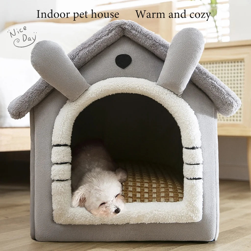 A gray indoor pet house shaped like a ram provides a warm and cozy shelter for a small puppy inside.