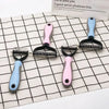 A set of pink and blue stainless steel pet hair removal comb brushes for dogs and cats displayed on a grid.