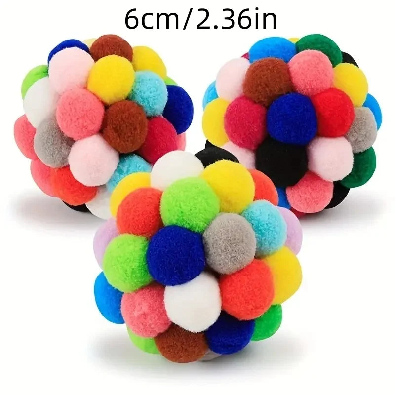Ein Set von sechs bunten, flauschigen Katzenspielzeugen in Form von Kugeln in verschiedenen Pink-, Gelb-, Blau-, Grün- und Br