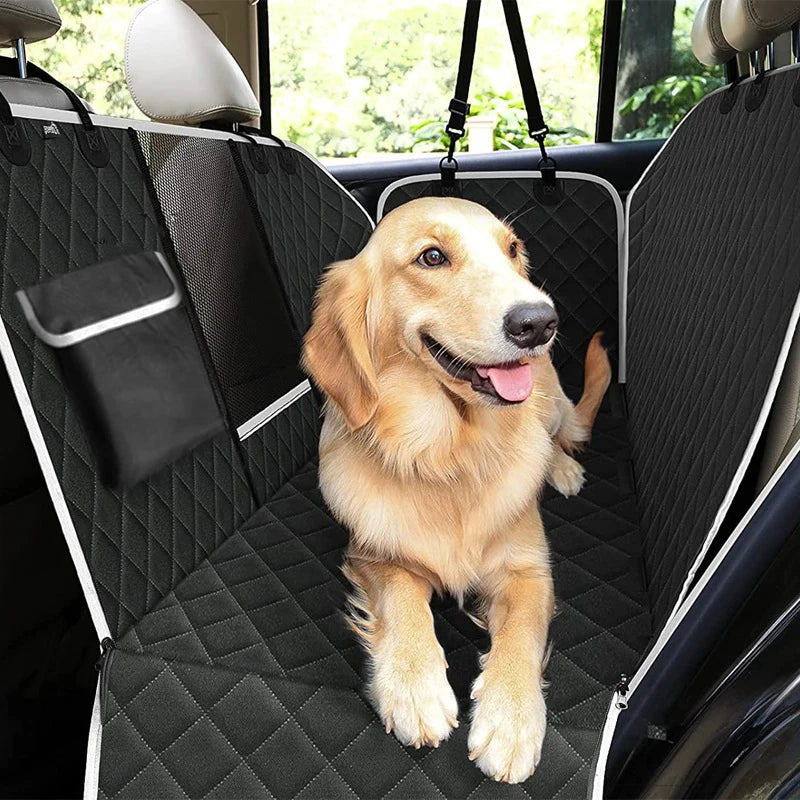 A golden retriever sits happily in a black waterproof dog car backseat cover.