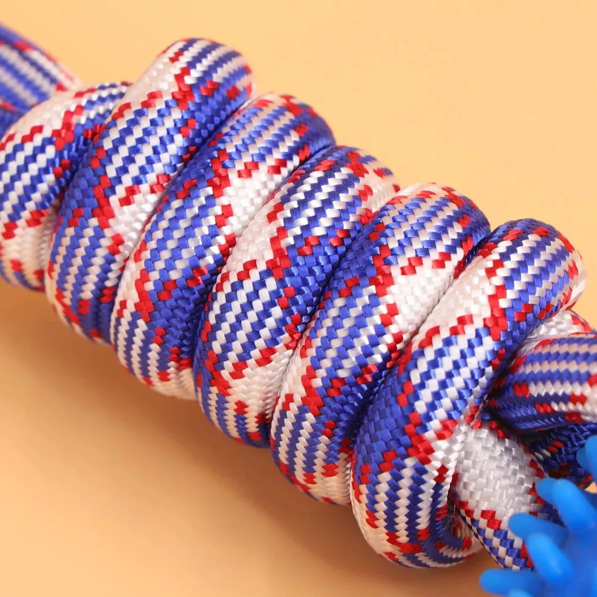 A close-up of a blue and white braided dental chew ring for dogs.