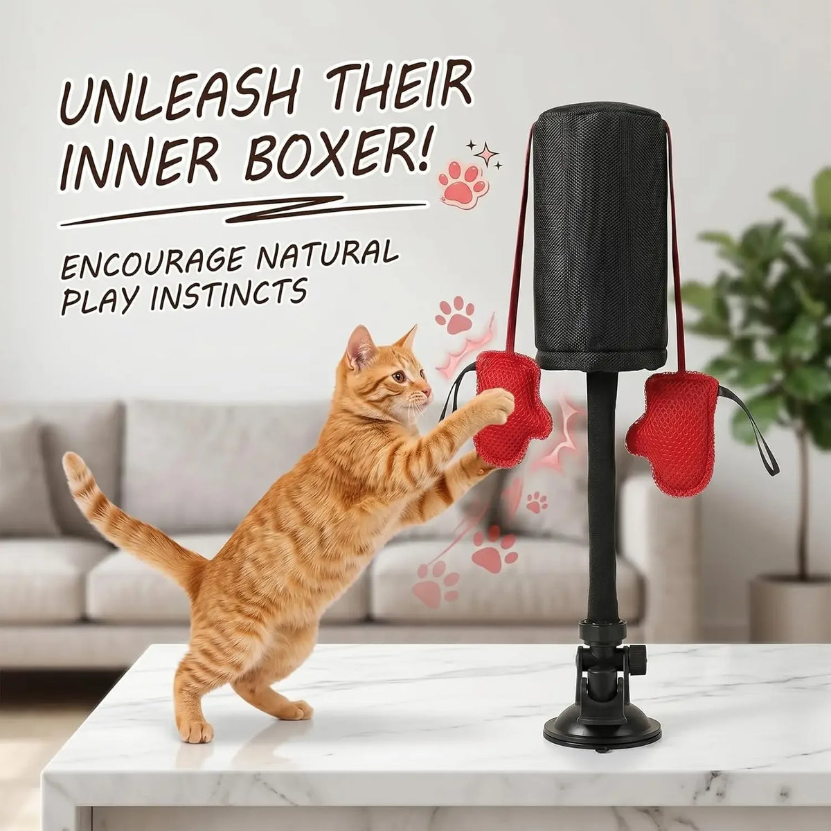 An orange tabby cat is playing with an interactive boxing bag featuring red gloves and a black stand.