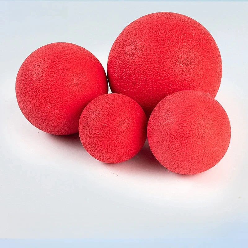 Three bright red rubber dog balls are shown against a white background.