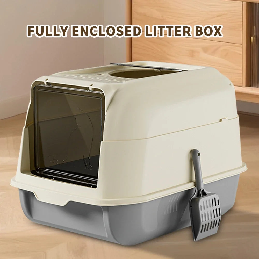 A fully enclosed litter box with a clear viewing panel and a gray base is shown on a wooden surface.