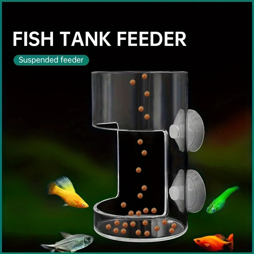 A clear suspended fish tank feeder with multiple small orange pellets and several small fish visible.