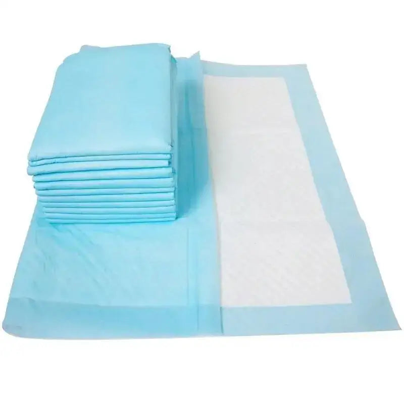 A stack of light blue disposable pet diapers for dogs and cats with a white absorbent pad.