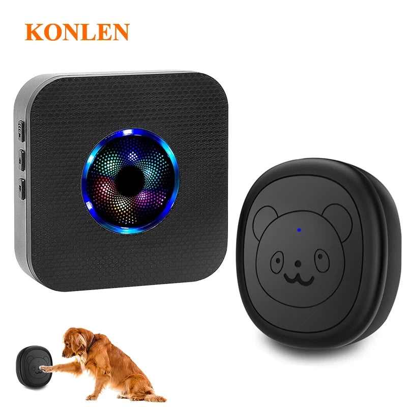 A black wireless dog doorbell with a circular light and a separate round component, shown next to a dog.