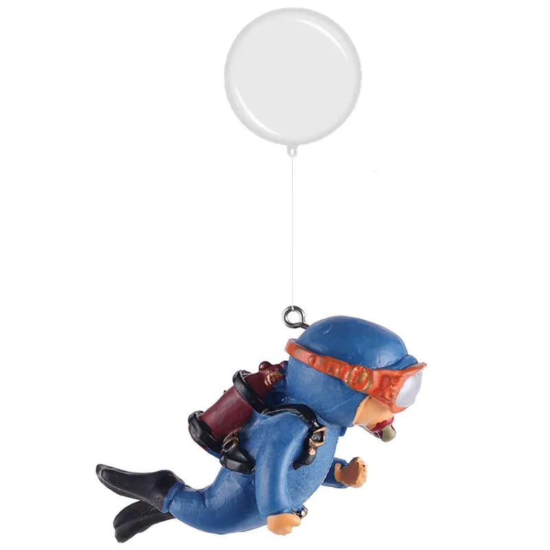 A resin mini diver aquarium ornament in blue and orange, suspended by a white balloon.