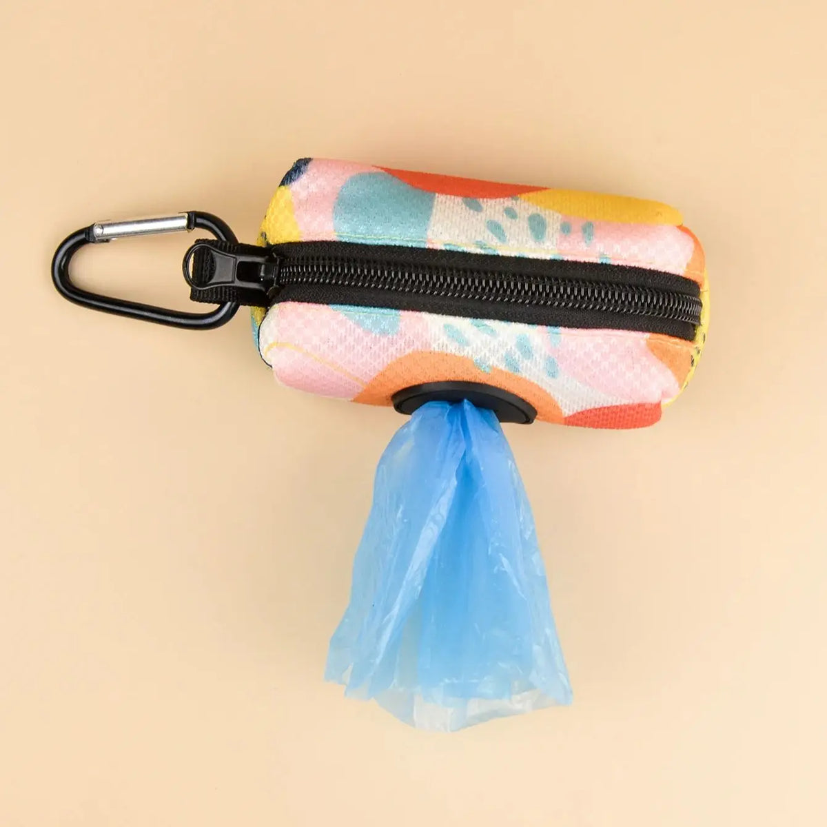 A colorful leash clip poop bag dispenser with a black zipper and a blue fabric pouch.