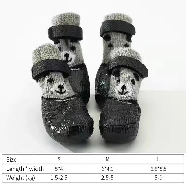 A pair of black pet paw protection socks with white paw prints for small dogs and cats.