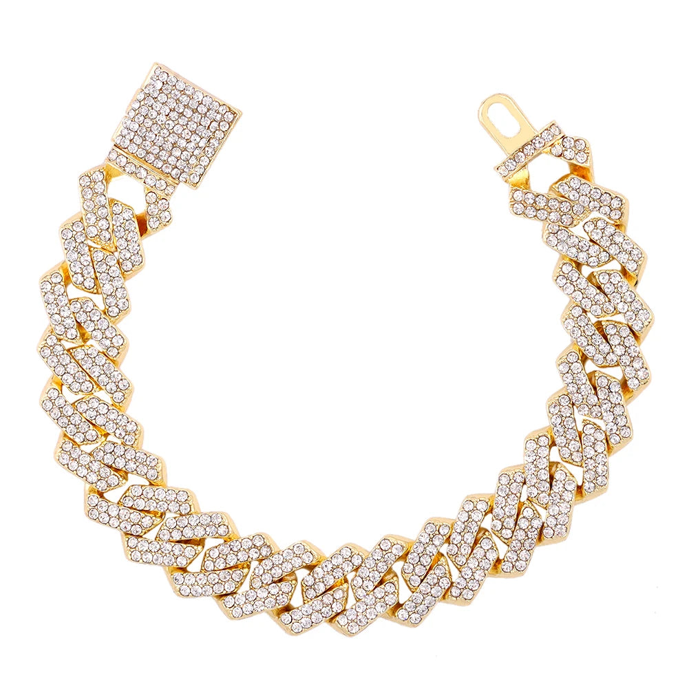 A gold iced-out Cuban link bracelet featuring rhinestone pavé detailing.