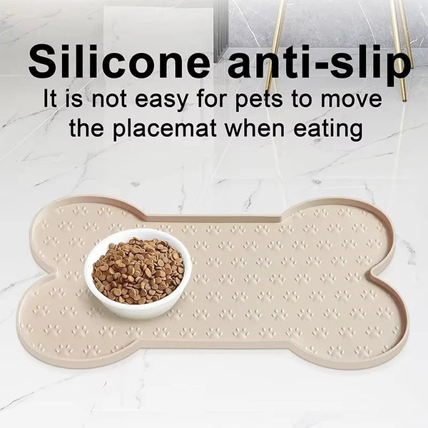 A beige silicone anti-slip pet feeding mat with a raised edge, placed next to a bowl of dry pet food.