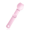 A pink squeeze spoon feeder for liquid cat treats with a rounded spoon tip and handle.