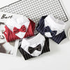 A collection of elegant striped tuxedo pet outfits for dogs and cats displayed on a black grid background.