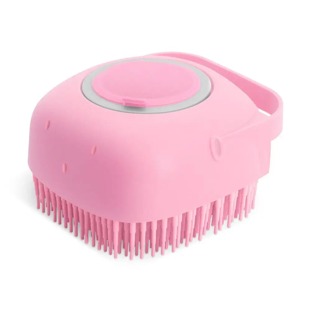 A pink silicone pet shampoo brush and grooming comb with a rounded head and bristles.