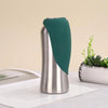 A silver portable dog water bottle with a teal built-in bowl is shown on a white surface.