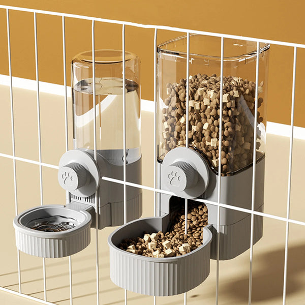 A silver automatic gravity pet feeder with two bowls is shown in a modern, light-colored setting.