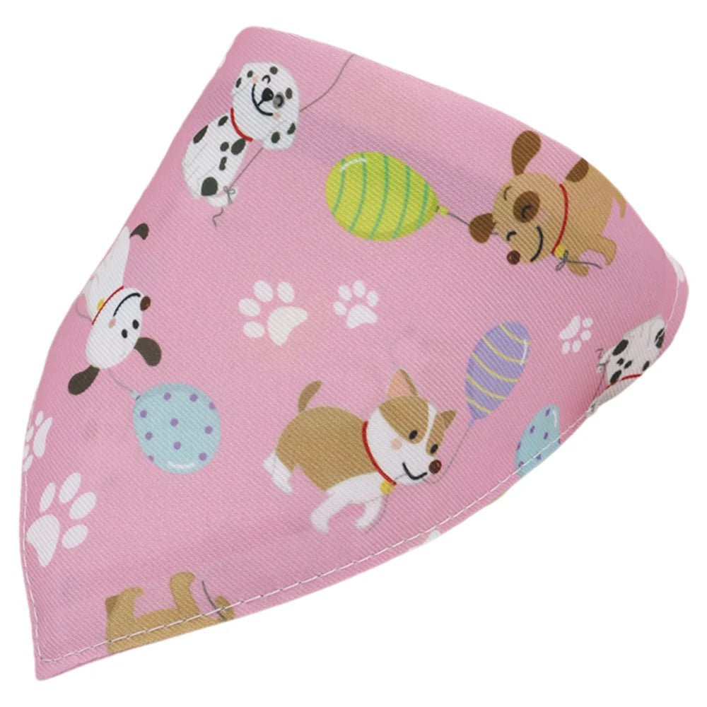 Pink cotton pet bandana with a cartoon print featuring dogs and paw prints