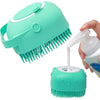 A hand is holding a teal silicone pet shampoo brush and grooming comb, showing both the head and the bristles.