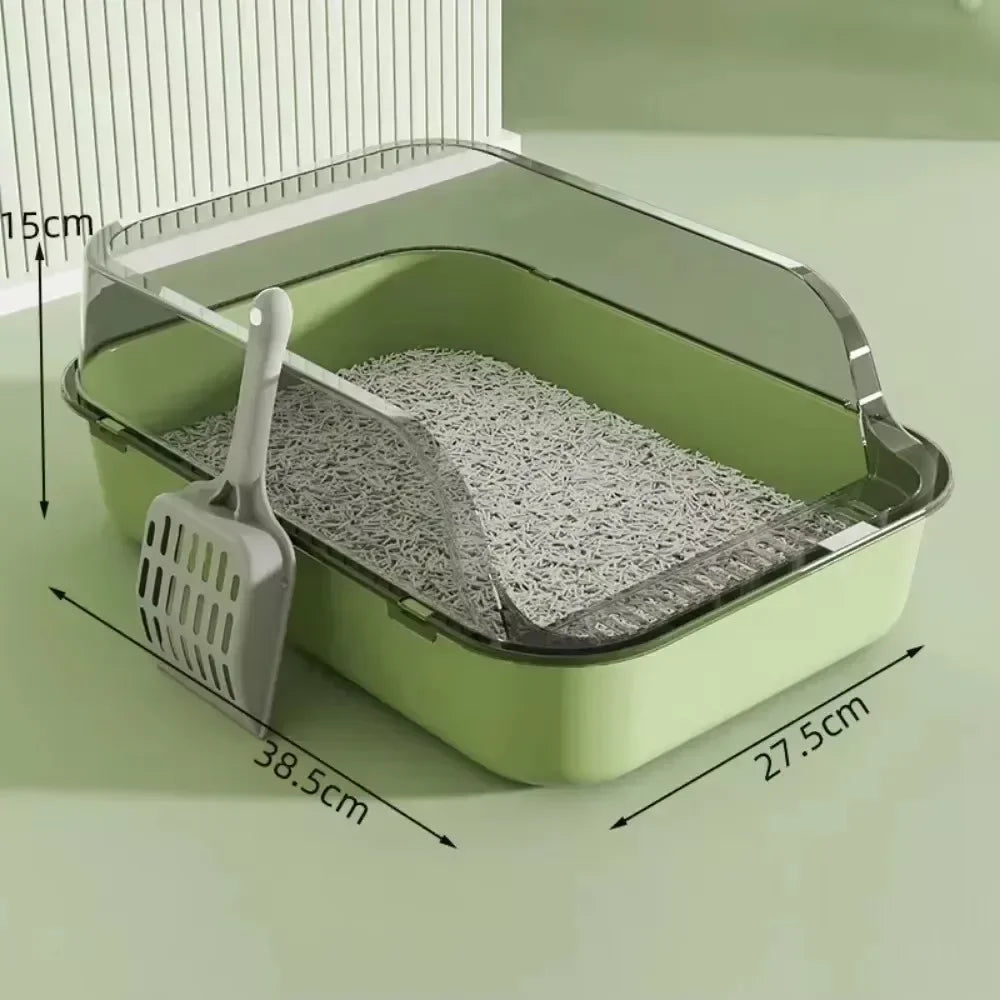Hellgrube Katzentoilette mit klappbarem Deckel und Schaufel auf einer Oberfläche.