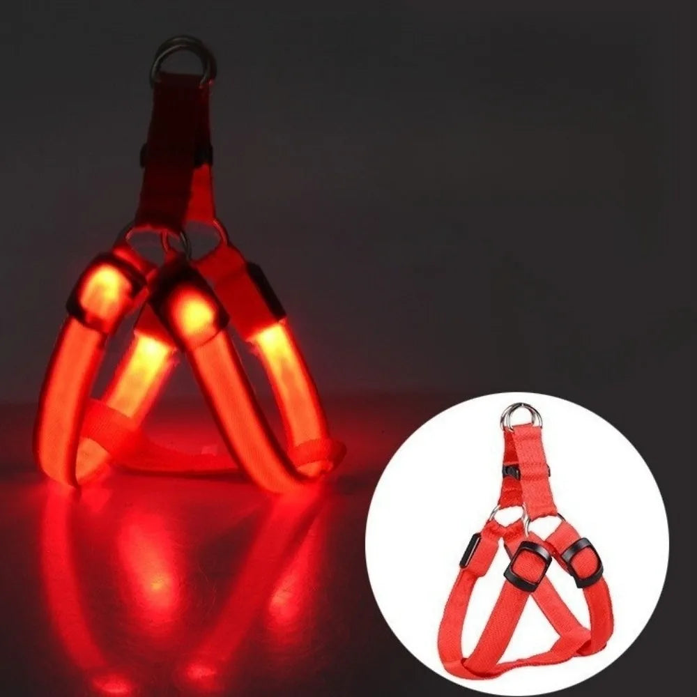 A bright red rechargeable LED dog harness with a mesh strap is shown against a dark background.