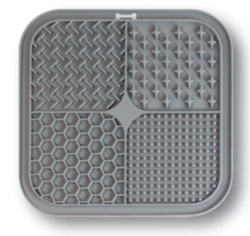 A gray silicone pet licking mat with suction cups designed for slow feeding of dogs and cats.