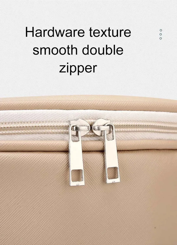 Close-up of a beige portable pet travel backpack featuring smooth double zipper hardware.