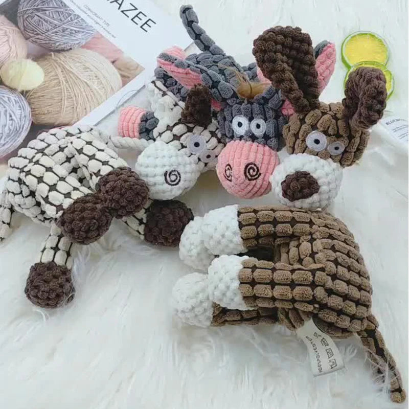 A collection of handcrafted knitted animal plush toys for dogs and cats, including a deer and other creatures.