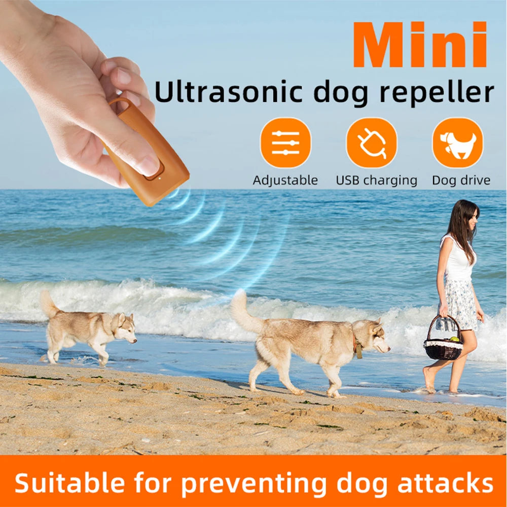 A hand holds an orange ultrasonic dog repeller device, demonstrating its use for preventing dog attacks.