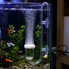 A clear glass aquarium setup showing aquatic plants and an acrylic CO2 diffuser with a bubble counter and control valve.