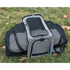A black and gray expandable pet carrier backpack with a mesh design is shown lying on green grass.
