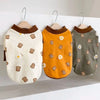 A pet vest for dogs featuring a cartoon print of toast on a cream fabric, an orange fabric, and a gray fabric.