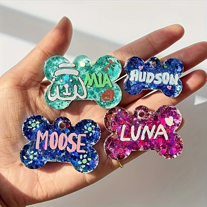 Hand holding four silicone dog bone molds for resin casting featuring names like Mia, Hudson, Moose, and Luna