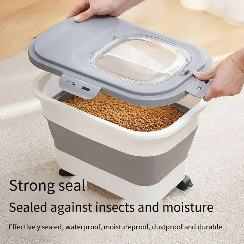 A gray and white collapsible airtight pet food storage container with a clear lid being held by a hand.