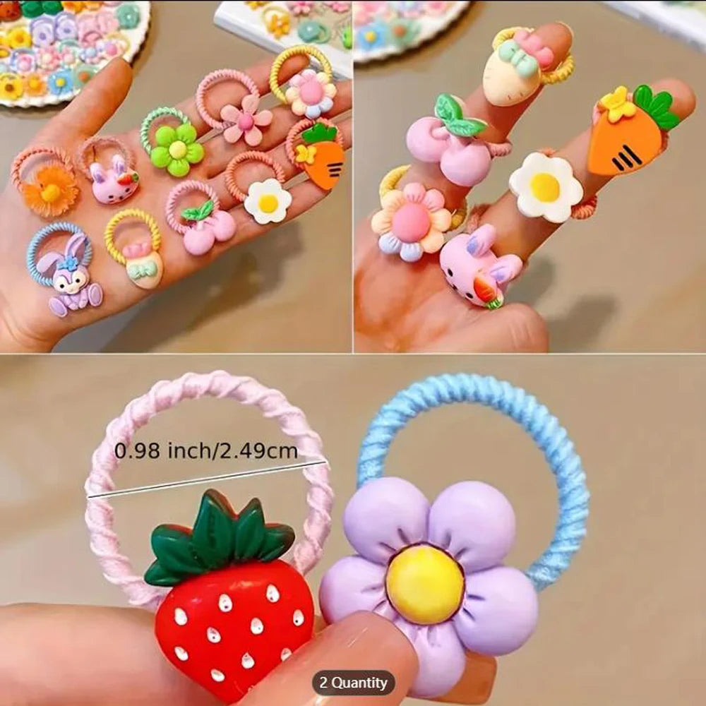 Assortment of cute cartoon elastic hair ties featuring various fruit and flower designs on a hand