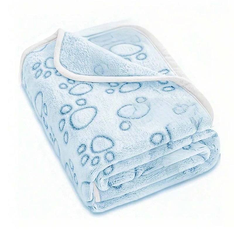 Light blue ultra-soft pet blanket with a paw print pattern folded neatly.